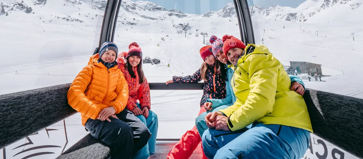 Friends laughing inside a gondola at Ordino Arcalís
