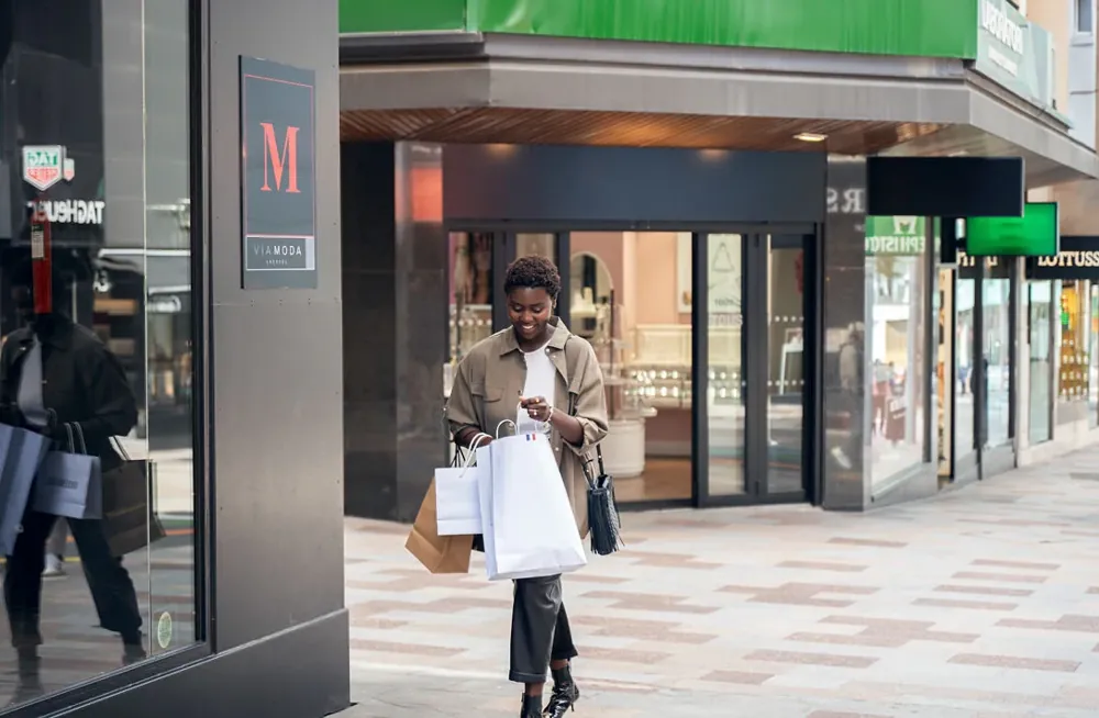 A shopper with bags in the centre of Andorra