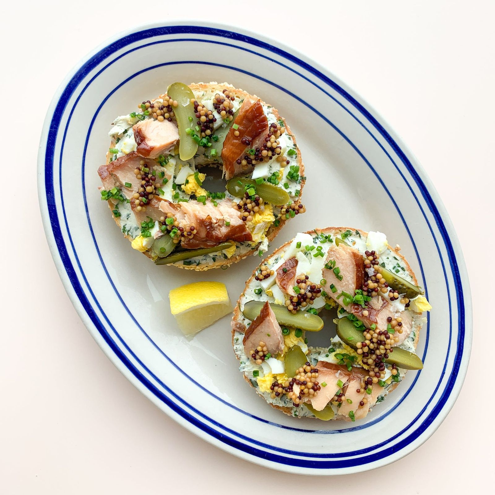 Smoked salmon on rice cakes on a blue-rimmed plate