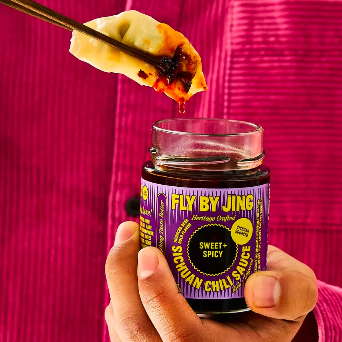 Dumpling dipped in Sweet + Spicy Sichuan Chili Sauce