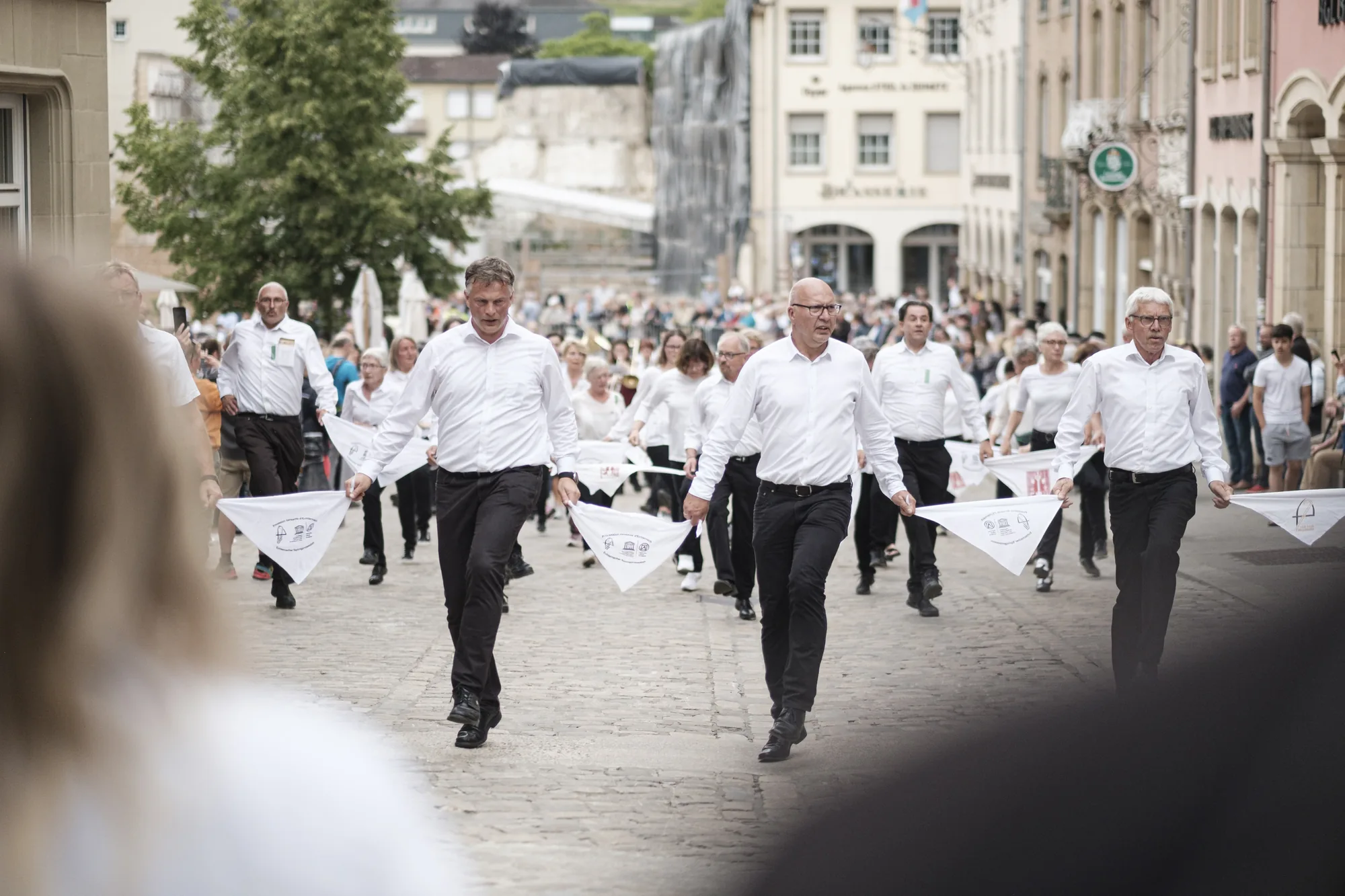 Dancers in white shirts at the Hopping Procession in Echternach